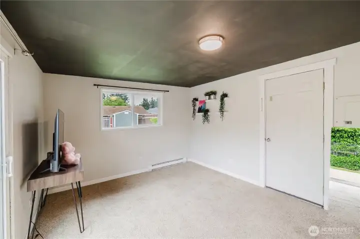 That door to the right goes to the side of the home. (The greenery to the right of the door is a mirror. It's reflecting the view from the other side.) That door to the right goes to the side of the home. (The greenery to the right of the door is a mirror. It's reflecting the view from the other side.)