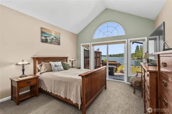 Primary bedroom with sliders leading out to the patio and Lake Tapps.