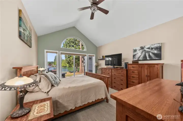 Main floor primary with oversized windows overlooking Lake Tapps