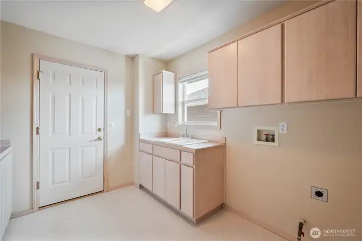 Main level laundry room with access to the three care garage