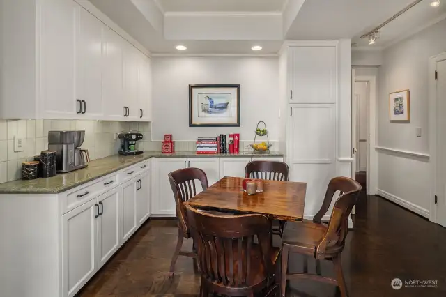 The kitchen offers plenty of casual dining space and abundant built-ins and cabinetry.