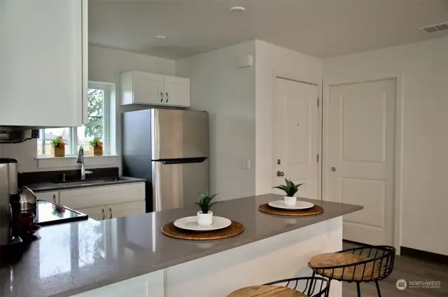 The kitchen has stainless steel appliance, and beautiful quartz countertops.
