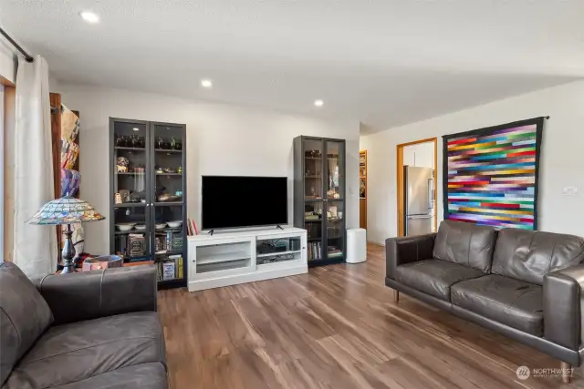 The living room offers ample space for a functional and versatile layout, allowing you to design the perfect setup for relaxation and entertainment. The updated easy care flooring adds a touch of warmth, enhancing the room's inviting and cozy atmosphere.