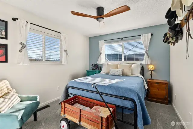 One of the three bedrooms on the upper level, each offers comfortable living space and convenient access to the nearby hall bath. This thoughtful layout ensures both functionality and ease for family and guests alike