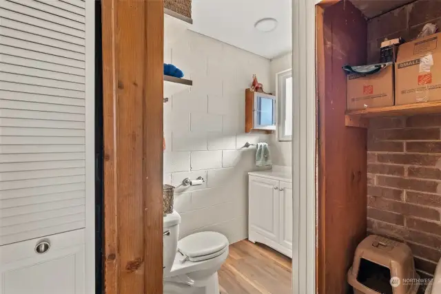 A second view of the lower-level half bath highlights the designated space for a future shower, with plumbing already in place. This setup offers great potential for customization, allowing you to complete the space to suit your needs and style