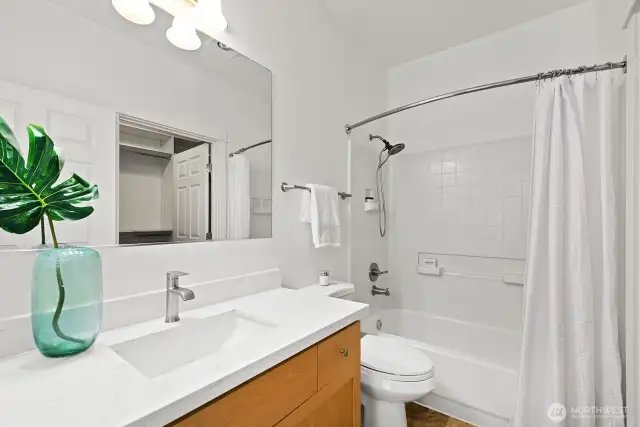 Primary ensuite with new quartz countertops and new sink.