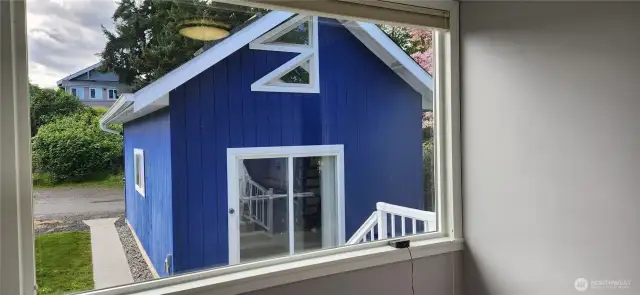 Looking out second bedroom to back garage