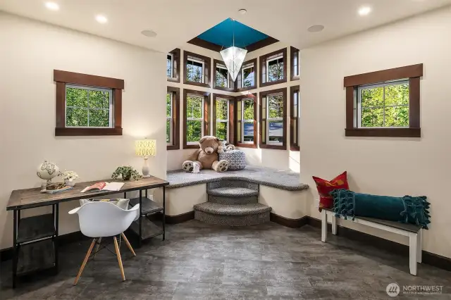 Carpeted bench in turret is the perfect place to read, work puzzles or play games