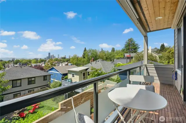 Covered balcony with cedar ceiling, freshly painted deck, teak tiles, and a decorative privacy screen.  Remote-control exterior blinds and sun shade to manage light and views with ease.