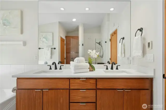 Quartz double vanity with updated faucets  Oversized Moen shower, low-profile soaking tub, and Toto bidet toilet in a private water closet