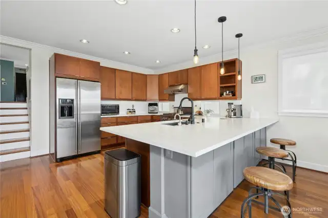 Custom cabinetry and 1¼” quartz luxury countertops with under-cabinet lighting