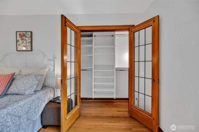 Large closet with French doors & built-ins.