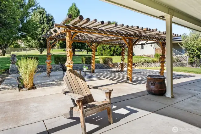 The centerpiece of the patio is a custom arbor made from select burl timbers