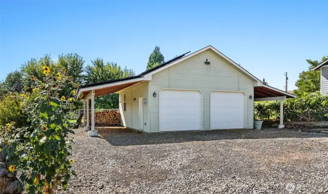 In addition to the attached garage, this detached two vehicle and shop structure  is the perfect spot for the hobbyist, artist or mechanic