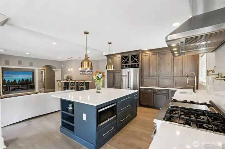 Fully remodeled kitchen with Wolf range, quartz countertops, and RH lighting
