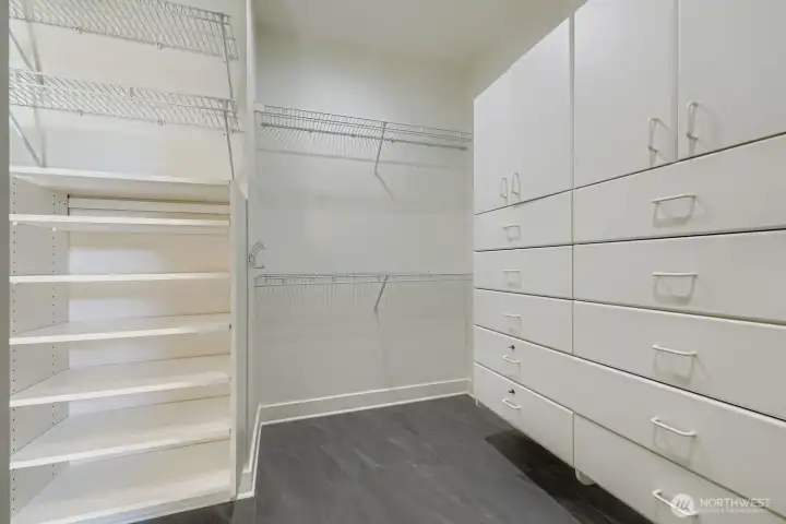 Walk-in closet with custom closet drawers and fxtures.