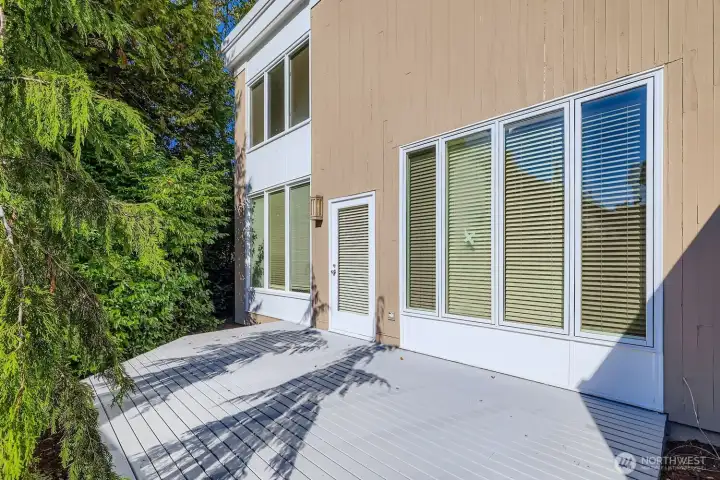Back private deck with partially fenced yard.