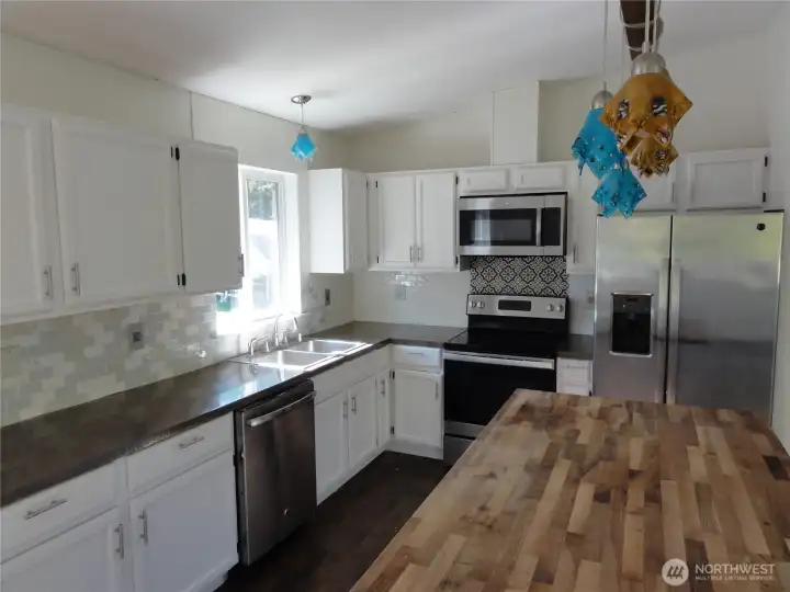 Huge kitchen with eating bar and island.