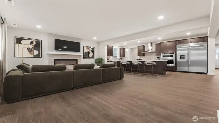 Great room view from 2nd main entry area.  Check out the cozy fireplace!  Actual home is under construction and materials, colors, and finishes will vary. See site agent for details.