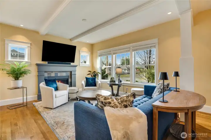 A cozy gas fireplace with a custom mantle and modern slate-tiled hearth adds inviting warmth, while a heat pump with A/C provides year-round, energy-efficient comfort.