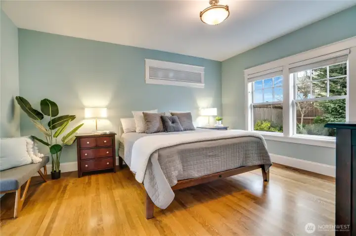 Soft morning light, peaceful backyard views, and thoughtful craftsmanship help to define this sophisticated main-floor primary suite.