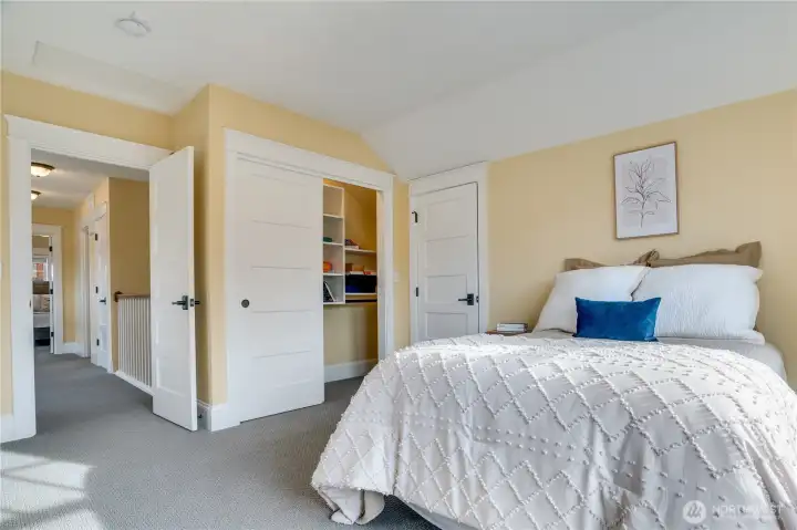 This bedroom also includes a large closet with additional organizers and access to another spacious finished eave storage area.