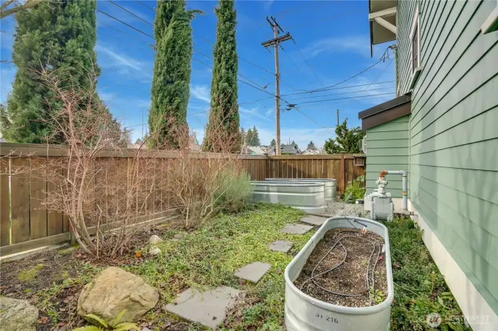 The fenced side-yard garden features galvanized steel raised beds and plenty of room to grow your favorites. Your new urban oasis is already set up and ready for you to dig in.