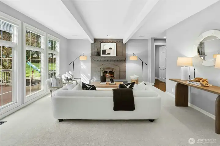 Another cozy gas fireplace with lush backyard views.