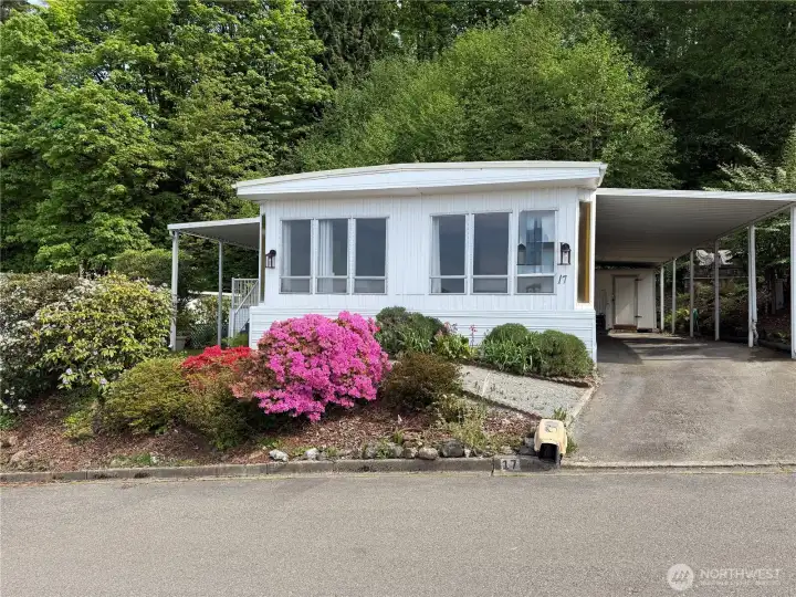 Your new "secret garden" is in Spring mode. Mature landscape with amazing color. This home features 2 bedrooms, a office, dining area, and two bathrooms.