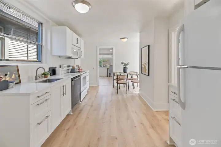 The kitchen was recently remodeled with new cabinetry, quartz countertops, new appliances, and LVP flooring throughout this main level.