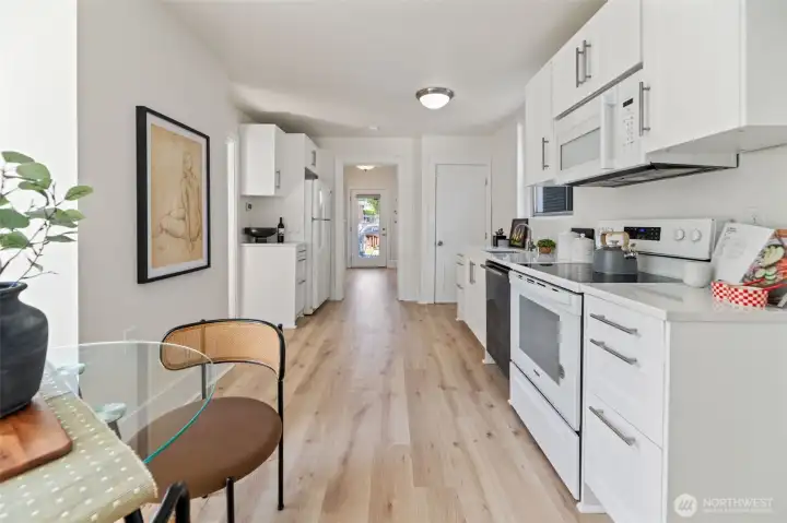 Another look at the kitchen towards the front door (middle of photo). The other door leads to the basement.