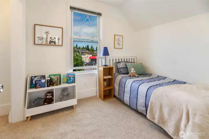 One of the bedrooms is smaller - perfect for a kid's room or office. This west-facing window showcases beautiful sunsets.