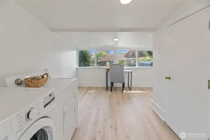 There is some bonus space past the laundry with several windows facing East towards the alley. This could be another office space or study nook. The door on the right is the 1/2 bath.