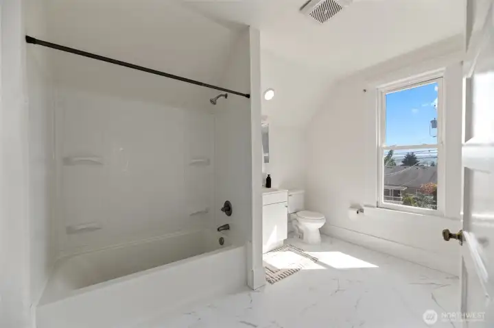 The upstairs bathroom is very spacious with fresh paint and new LVT (luxury vinyl tile).