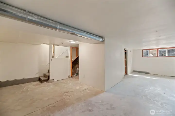 The basement is partially finished with good ceiling height and drywall in these areas.