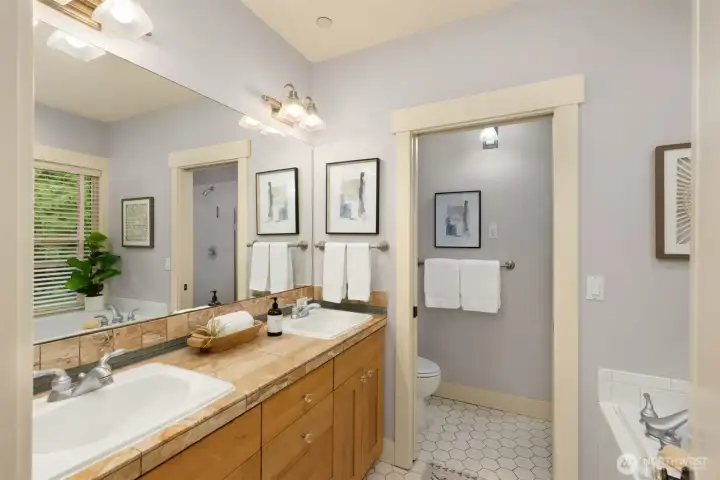 The well-appointed primary bath features quality finishes and includes a private water closet.