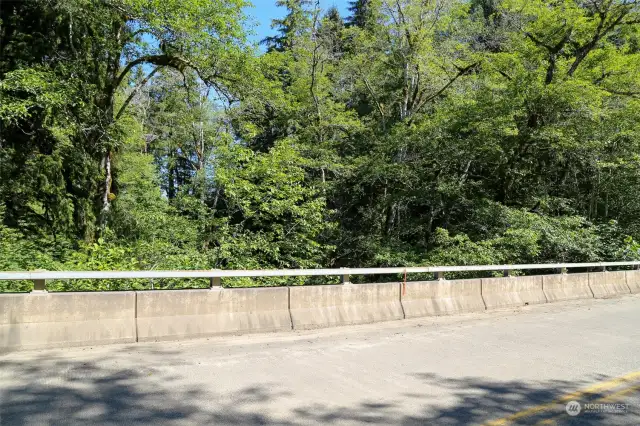 On Map - Point E.  This is property line corner area along the road/bridge.  the middle of the creek is the corner of the proeprty to the south. Points are estmated on Pictures. Stakes are present to show points and lines.