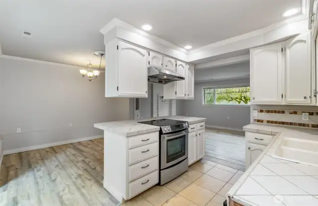 Light & Bright~Shiny & White~Main Level Kitchen Located Smartly Between the Dining Room~Sitting Area~Patio~Pluck Fresh Herbs from your Garden & Pick Fresh Eggs~Chicken Coop not Shown, but Included~Bring your own Chicks!