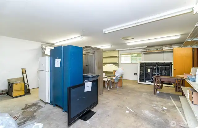 "Work~Shop" area of the Garage~Ample Benches~Electrical & Lighting for Projects Big & Small~Miscellanous "Donation" items will be cleared out Prior to the Weekend.