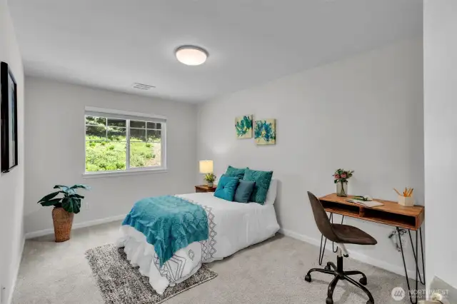 First of three upstairs bedrooms with view up the green hillside dotted with spring wildflowers.
