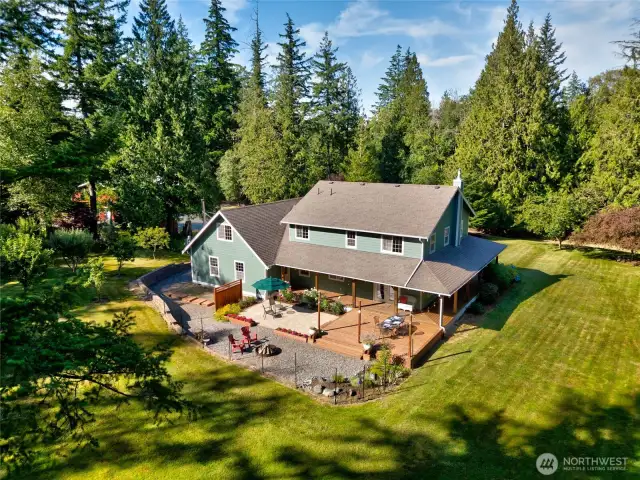Enjoy picturesque views of the spacious backyard and entertaining areas, featuring a wrap-around porch that provides ample room for relaxing, socializing, and taking in the serene surroundings.