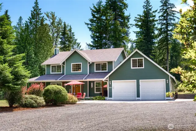 A spacious circular driveway provides easy entry and exit, making it effortless to pull in and back into the dedicated RV parking site along the side of the home. The setup includes water and electrical hookups, perfect for long-term parking, visiting guests, or your next adventure-ready rig.