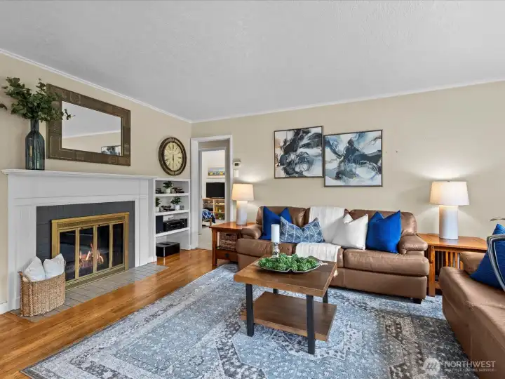 Spacious living room with wood-burning fireplace and so much natural light