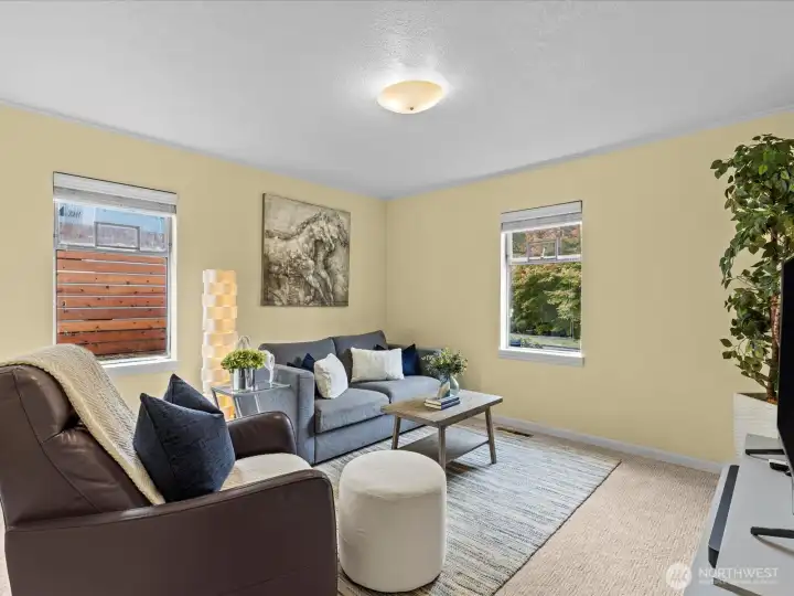 Bedroom #1 is spacious with a lot of natural light; can be repurposed as a TV or game room as shown.