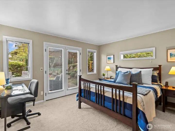 Primary bedroom with gorgeous French doors that lead out onto the back deck.
