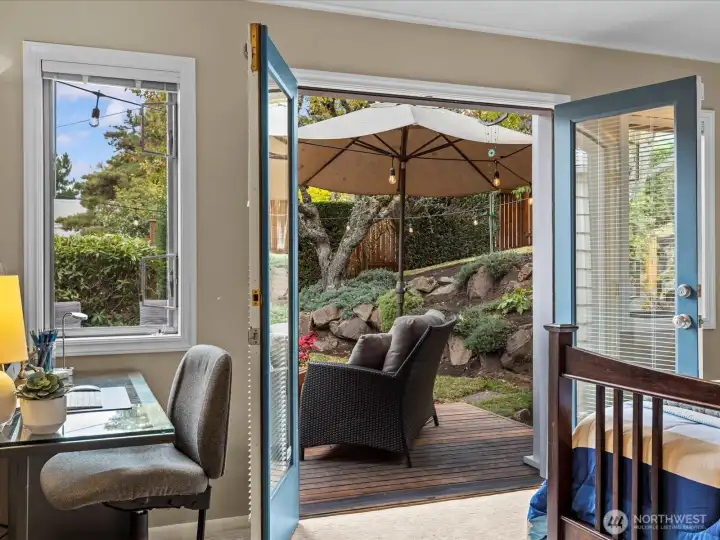 Primary Bedroom featuring French doors out to back deck. Can you imagine stepping out for your first cup of coffee in the morning? So inviting and private.