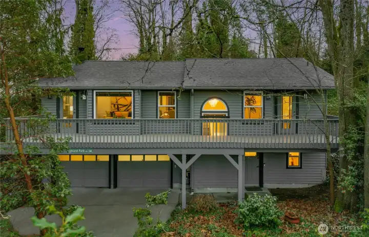 Private Highland Park sanctuary with two-car garage and upper-level deck set among mature trees.