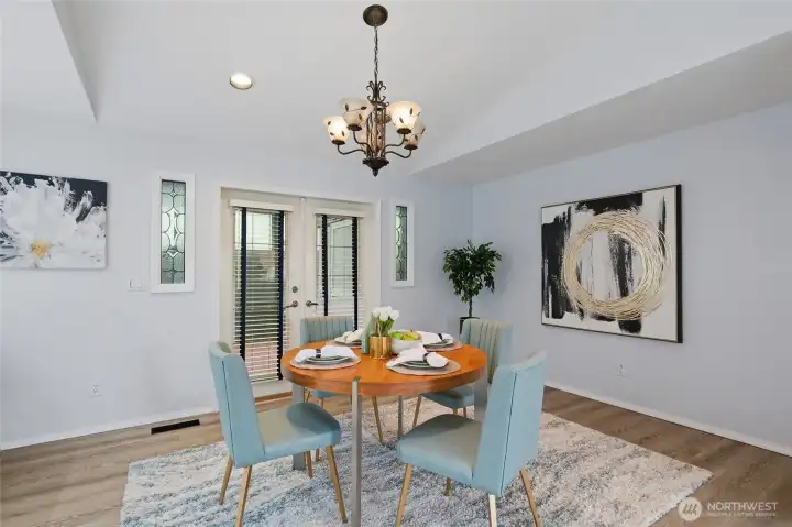Refined dining area features decorative glass accents and seamless indoor-outdoor connection to private deck.