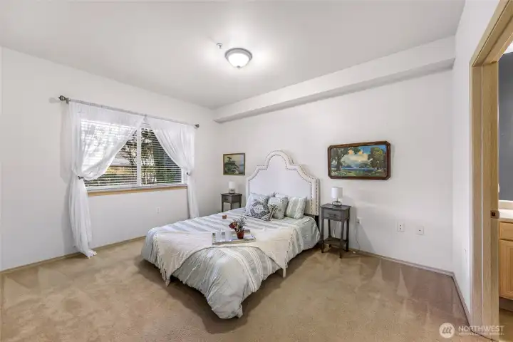 The large primary bedroom with space for dressers and bedroom furniture.