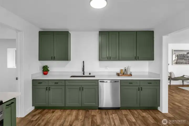 To the left you'll find the laundry room with an entrance to the garage